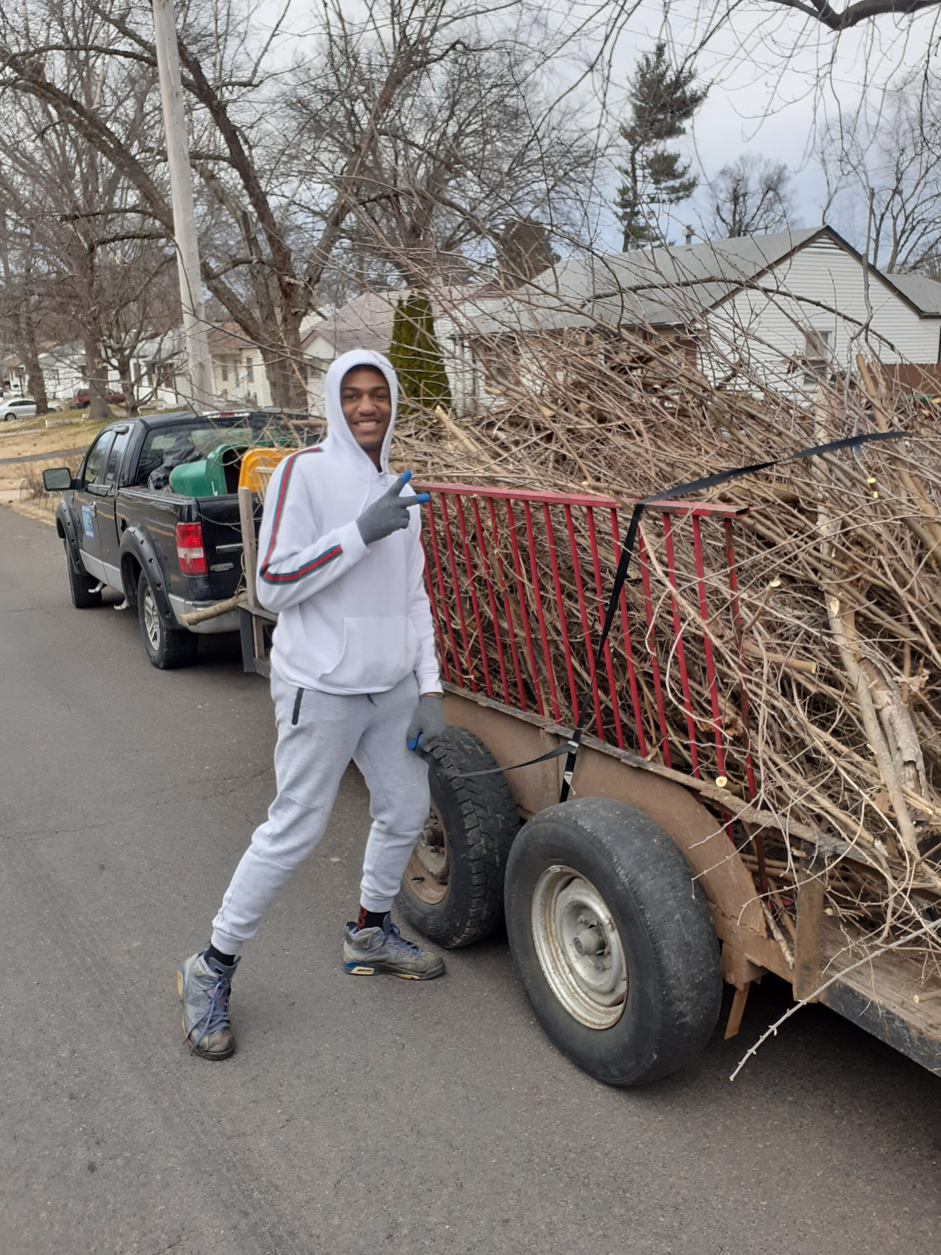 Man Poses Beside the Tree Branches in the Truck